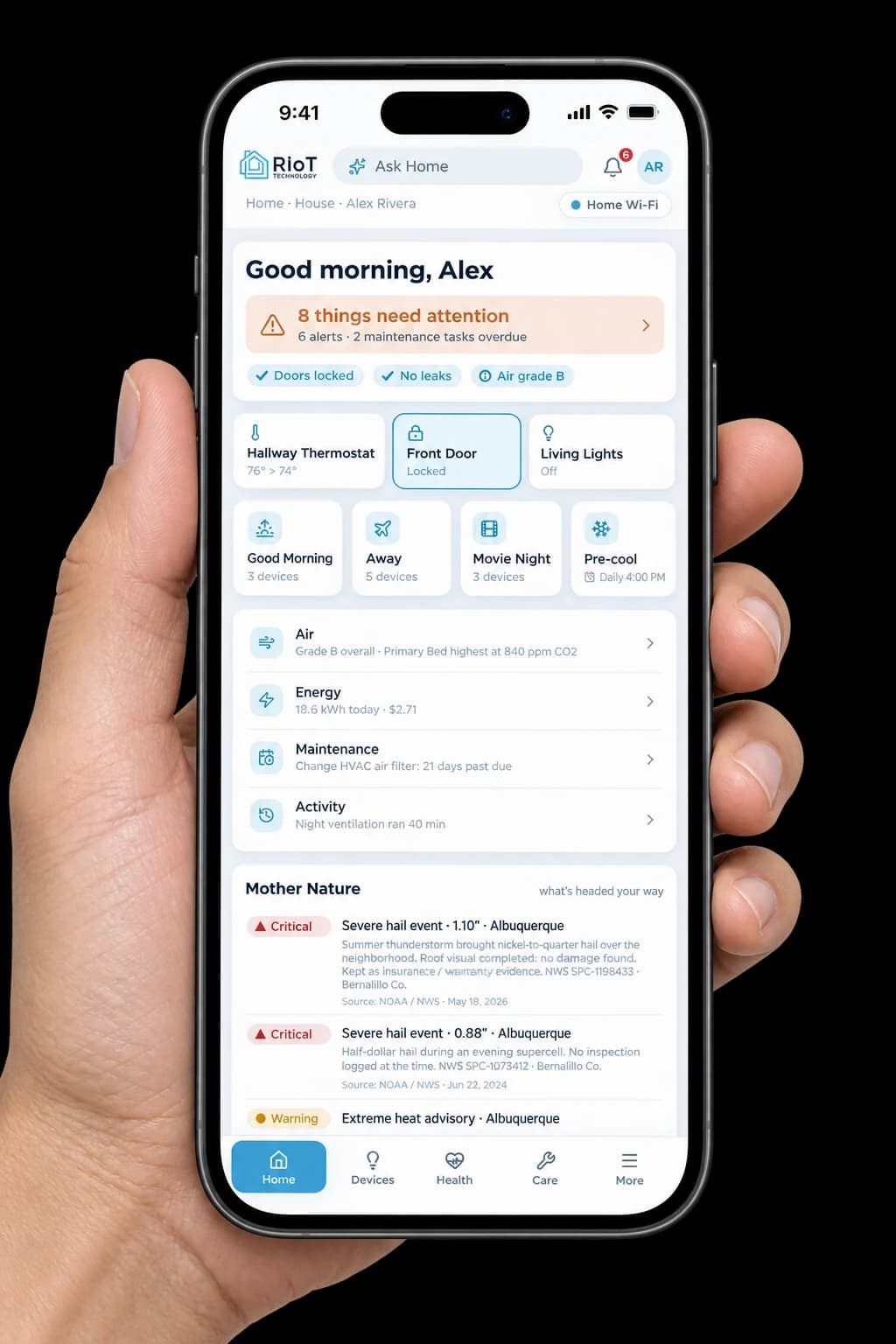 RIoT Home app on a phone held in a hand